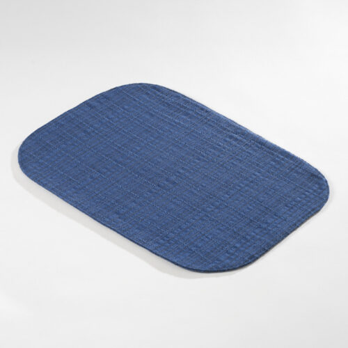 Galaxy premium royal blue oval textured woven placemat showing rounded corner profile on a light grey background.