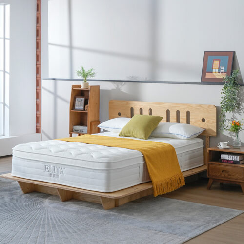 White luxury euro top hotel mattress with plush cushion layer on a wooden platform bed frame.