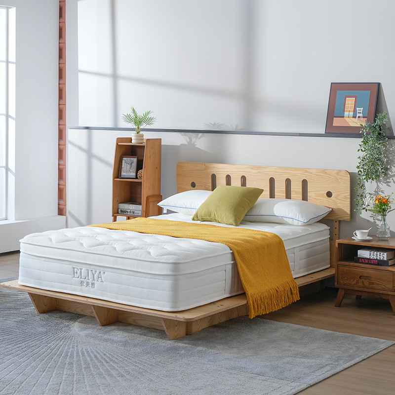 White luxury euro top hotel mattress with plush cushion layer on a wooden platform bed frame.