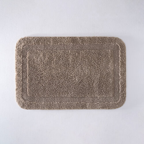 Galaxy premium camel taupe plush cotton bath mat lying flat on a light grey background.