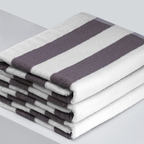 Stack of dark grey and white striped resort pool towels.
