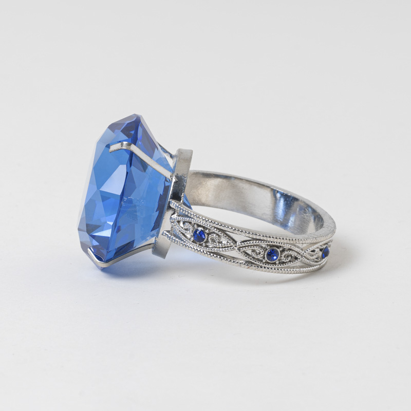 Galaxy vintage royal sapphire crystal ring napkin holder with silver filigree band on a clean white background.