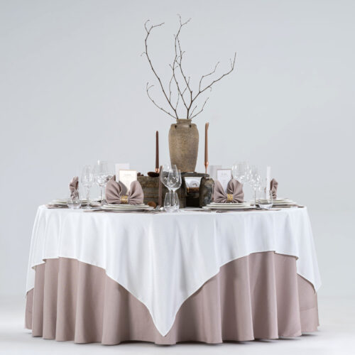 Product collage of a hotel round banquet table styled with a dusty rose skirt, white square overlay, embroidered placemats, and fan-folded napkins with gold rings.