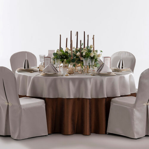 Product collage of a hotel round banquet table styled with champagne jacquard overlay, bronze base skirt, silver chair covers, and tall candelabras.