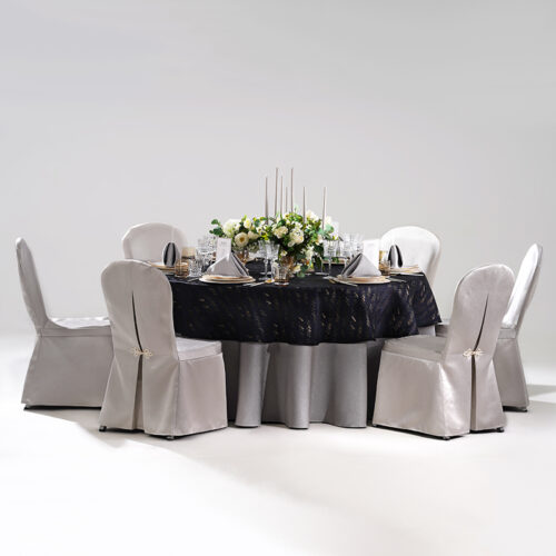 Gallery showing hotel banquet table setting details including silver jacquard chair covers, dark tablecloth, grey napkins, glass stemware, and candelabra.